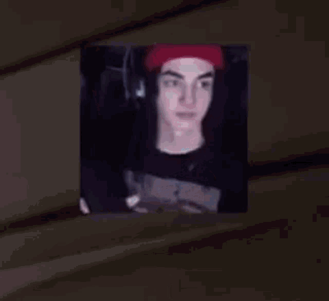 a man in a red hat is holding a keyboard with the words `` mnk confirmed '' below him .