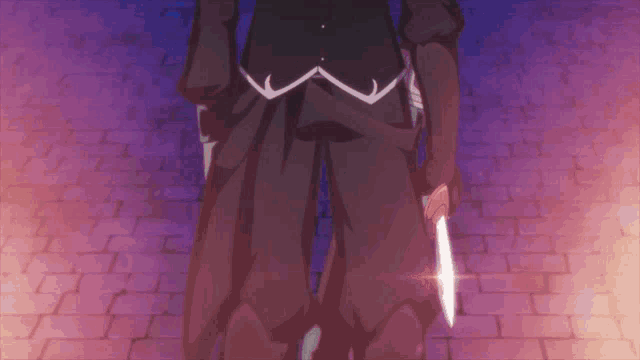 a man in a black suit is holding a knife in his right hand
