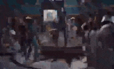 a blurry picture of a building with a clock on the wall