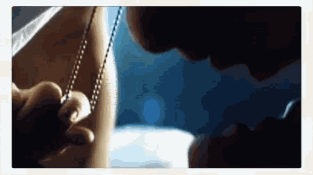 a close up of a person holding a chain around their neck