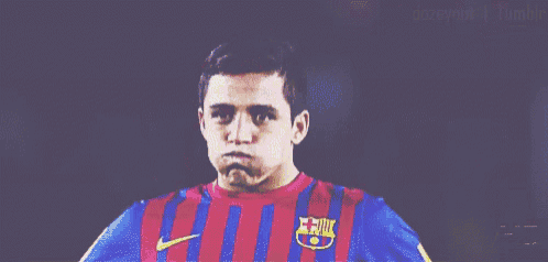 a soccer player wearing a striped shirt with a fcb logo on it