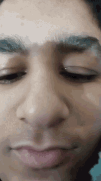 a close up of a man 's face with his eyes closed and his eyebrows visible