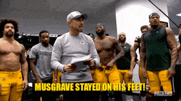 a group of green bay packers players stand in a locker room with the caption musgrave stayed on his feet