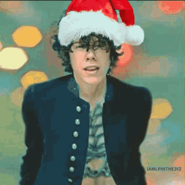a man wearing a santa hat has the hashtag iamlpinthe312 on the bottom