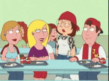 a group of people sitting at a table with one wearing a jacket that says j.w.