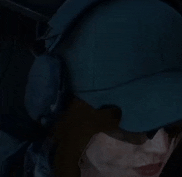 a close up of a person wearing sunglasses and a hat .