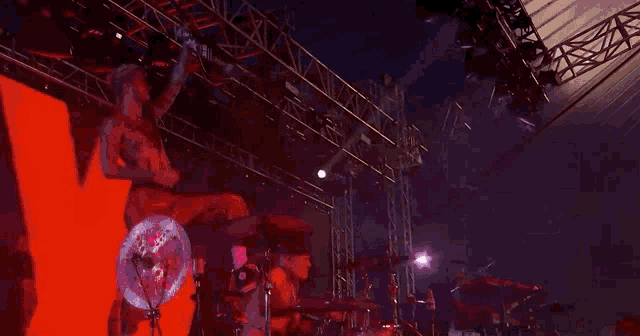 a person in a wheelchair playing drums on a stage