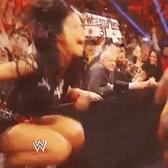 a woman is kneeling down in front of a crowd with a w logo on her leg