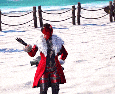 a woman in a red coat and mask is standing on a snowy beach