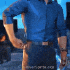 a man in a blue shirt and black pants is standing in front of a riversprite.exe icon