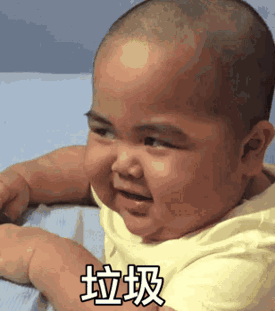 a baby laying on a bed with chinese writing on it
