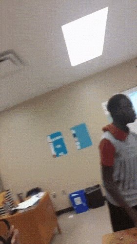 a person standing in a room with a sign that says a on it