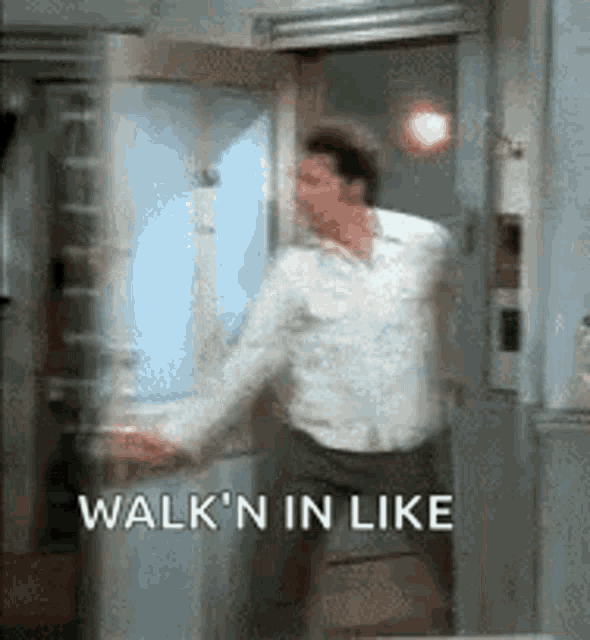 a man is standing in a doorway with the words `` walk n in like '' written on the bottom .