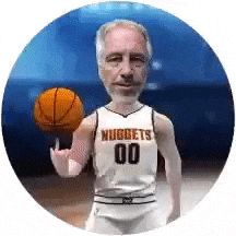 a man in a nuggets jersey is holding a basketball