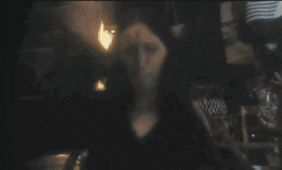 a woman is standing in front of a glowing object