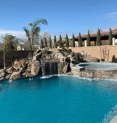 a swimming pool with a waterfall in the background