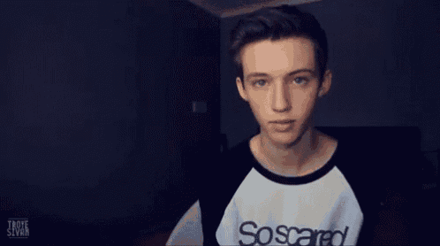 a young man wearing a shirt that says ' soccer ' on it is making a funny face