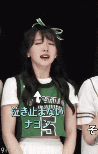 a girl wearing a green shirt that says twice on it