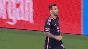 a soccer player in a black jersey with the number 18 on it