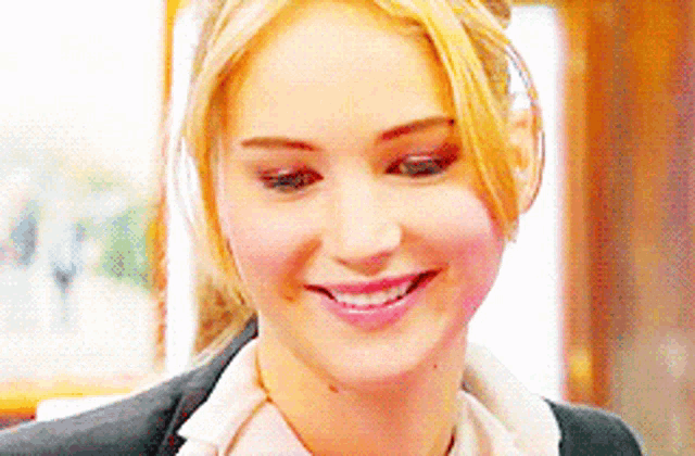 a close up of a woman 's face with a smile on it