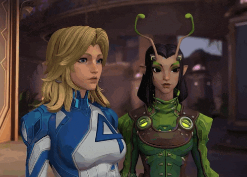 a woman in a blue suit with the letter a on it stands next to another woman in a green suit