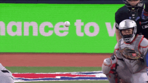 a baseball player catching a ball in front of a green sign that says finance to vote