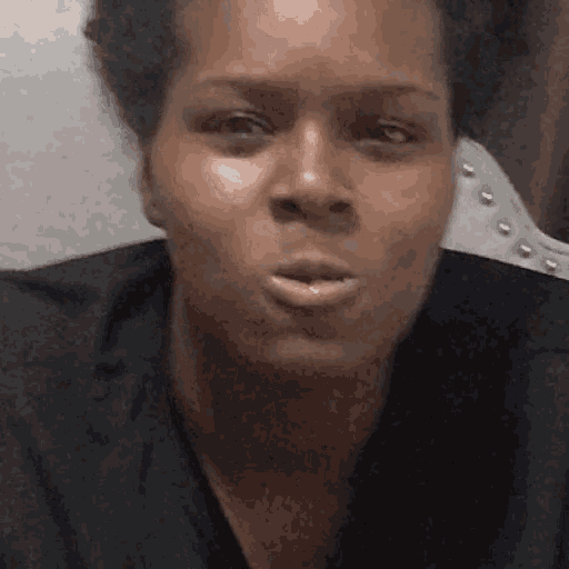 a close up of a woman 's face with a black shirt