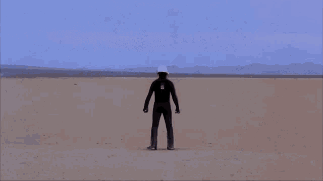 a large explosion in the middle of a desert with smoke coming out of it