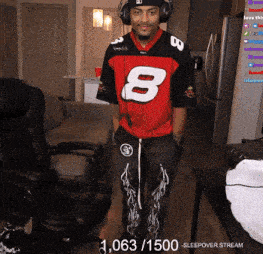 a man wearing headphones and a red jersey with the number 8