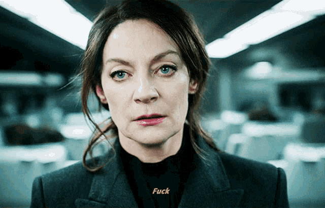 a woman with a black shirt that says " fuck "