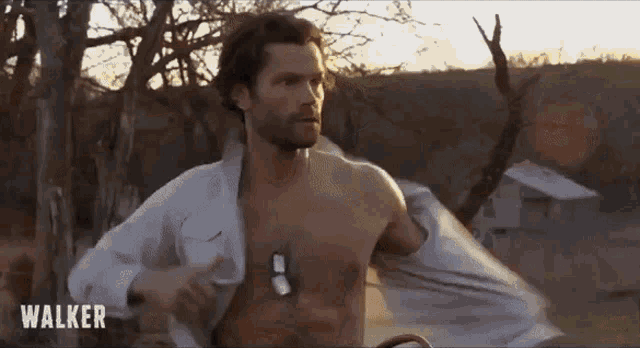 a shirtless man is standing in a field and the word walker is on the bottom