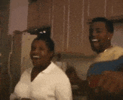 a man and a woman are dancing in a kitchen .