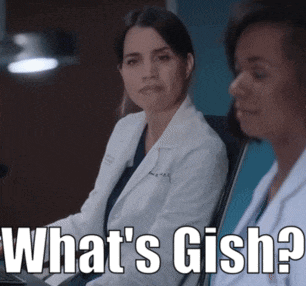 a woman in a lab coat is sitting next to another woman with the words what 's gish written on it
