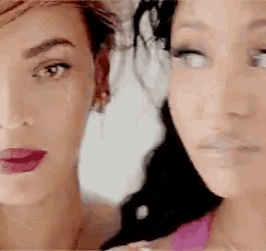 a close up of two women 's faces with their eyes closed