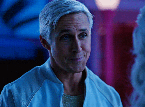 a man with gray hair is smiling and wearing a blue jacket