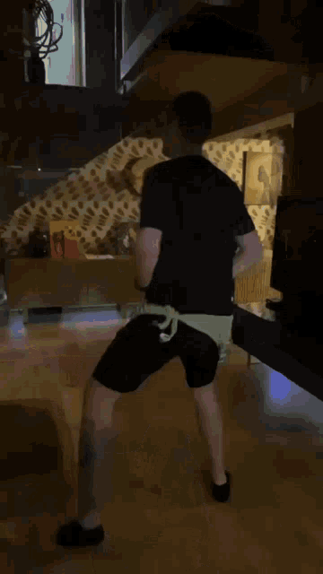a woman is dancing in a room with a giraffe in the background .