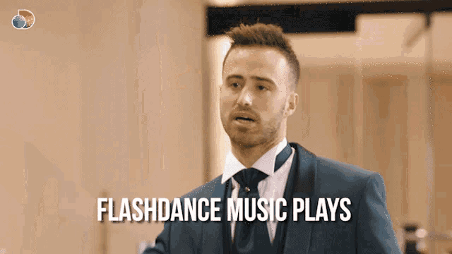 a man in a suit and tie with the words flashdance music plays