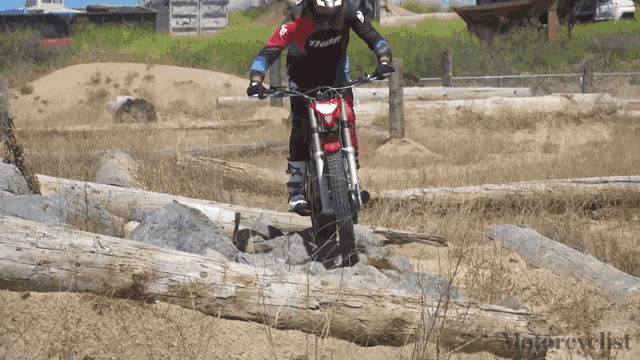 a person riding a motorcycle in a field with the word motorcycle on the bottom