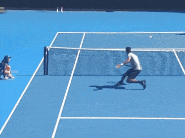 a man in a yellow shirt is playing tennis