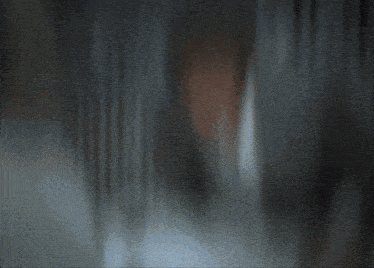 a blurred image of a dark room with a few lights visible