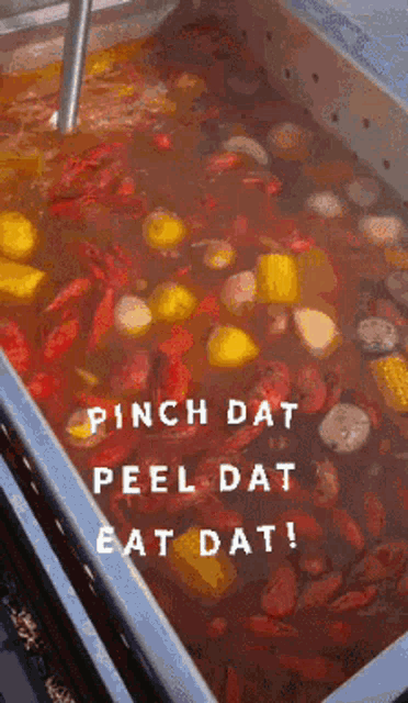a large pot of food with the words pinch dat peel dat eat dat on the bottom
