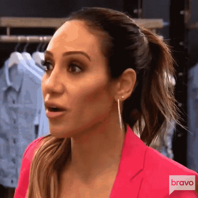 a woman wearing a pink jacket with the word bravo on the bottom