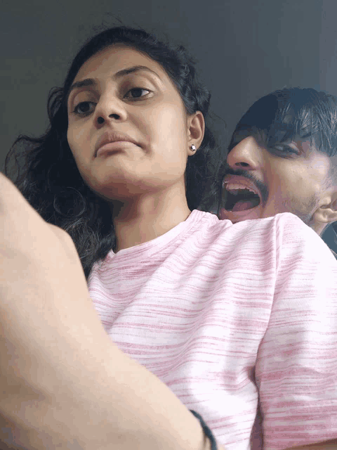 a man and a woman are making funny faces