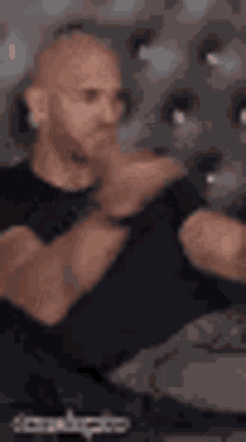 a man wearing a black shirt with the word slap on it .