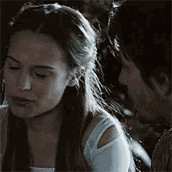 a man and a woman are looking at each other .