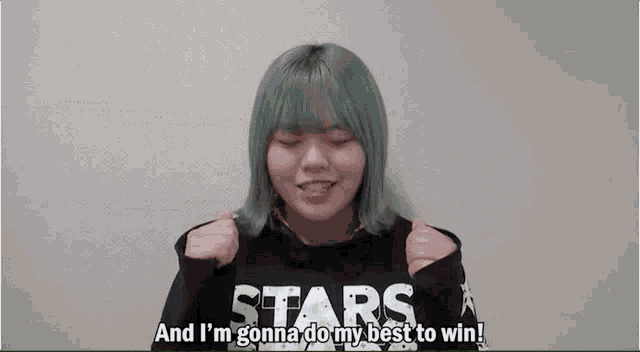 a girl with blue hair is wearing a black sweater that says stars and i 'm gonna do my best to win .
