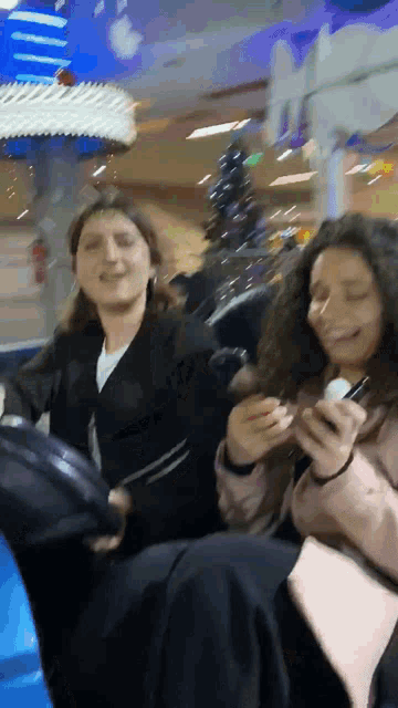 a man and a woman are riding a roller coaster