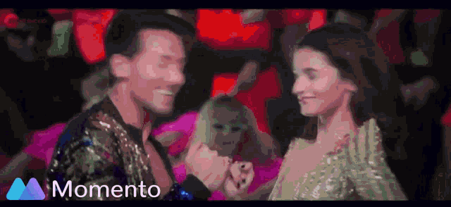 a man and a woman are dancing in a club and the words momento are above them