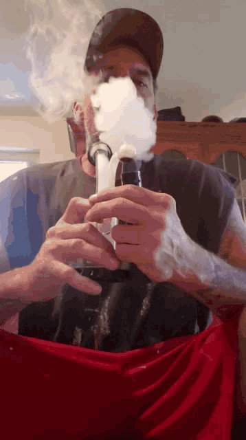 a man is smoking a bong with smoke coming out of his mouth