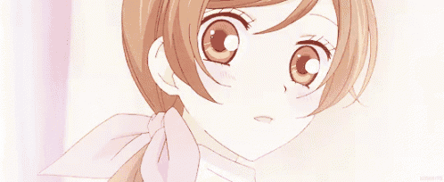a close up of a cute anime girl with brown hair and a pink scarf .